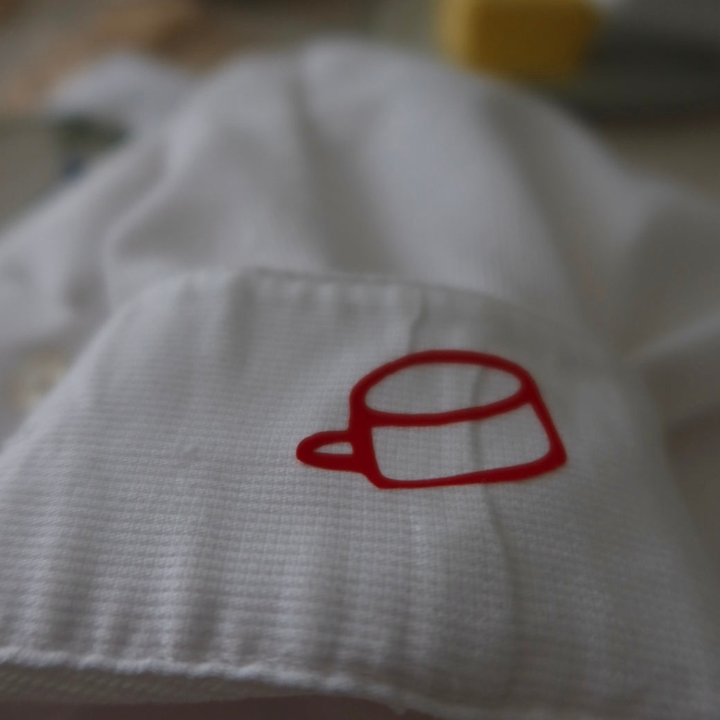 White fabric with a red cup design on a blurred background