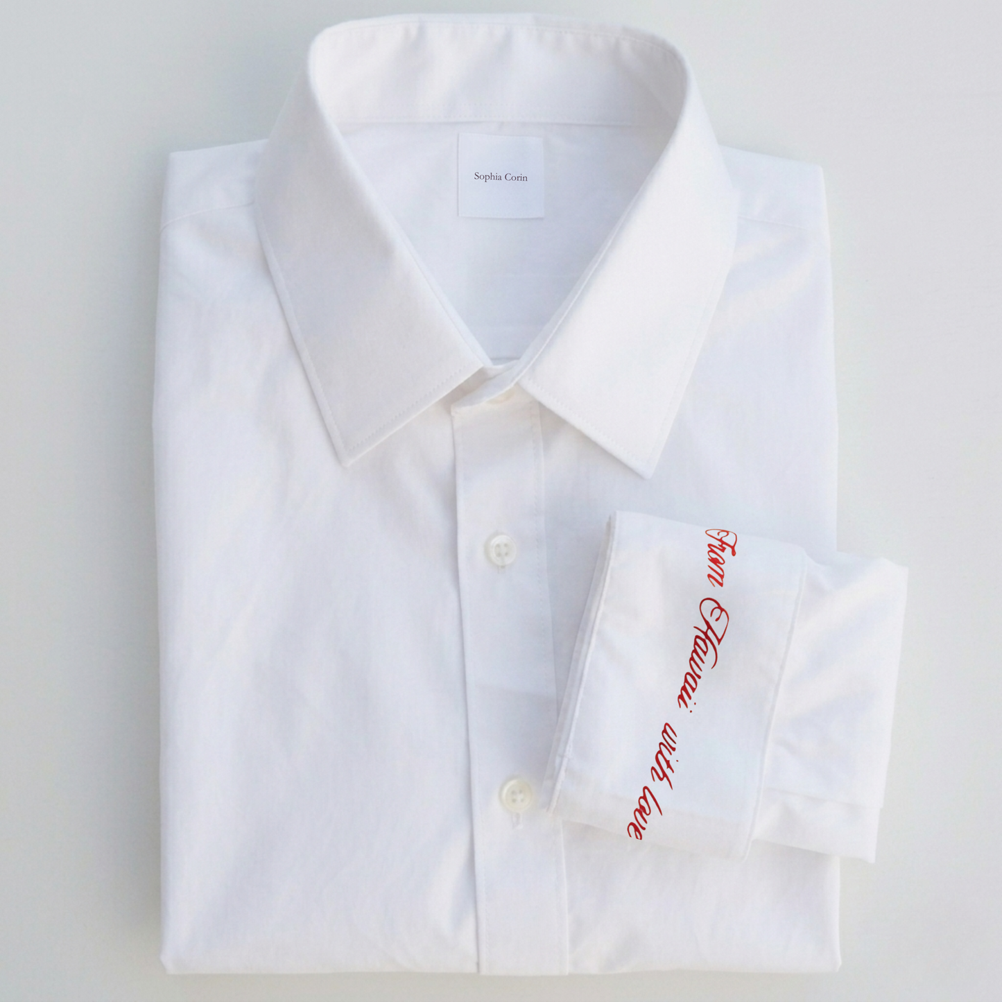 White dress shirt with red text on a light gray background