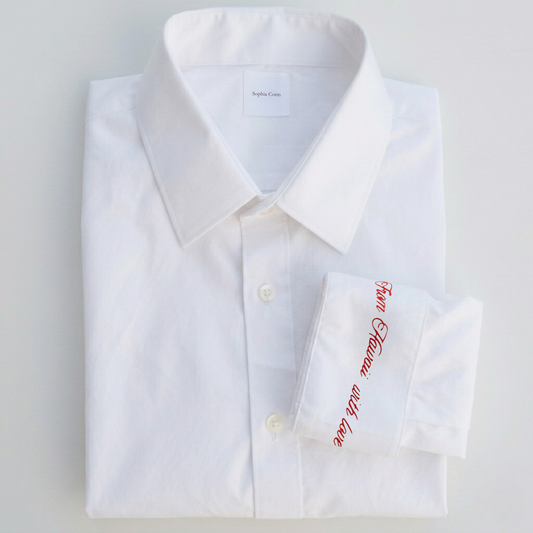White dress shirt with red text on a light gray background