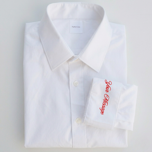 White dress shirt with red embroidery on a light gray background